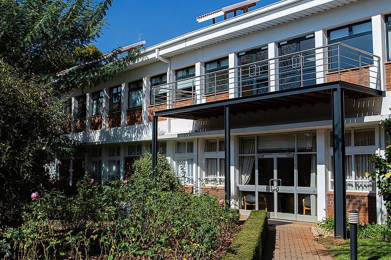The modern glazed ward wing seen from the hospital garden.