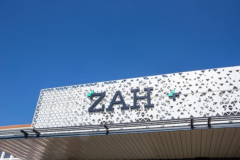The ZAH lettering on the perforated canopy above the hospital entrance.