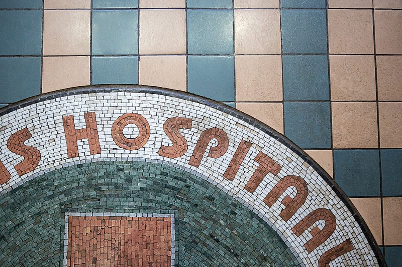 Close detail of the 1904 mosaic floor, the word “Hospitaal” set in tile.
